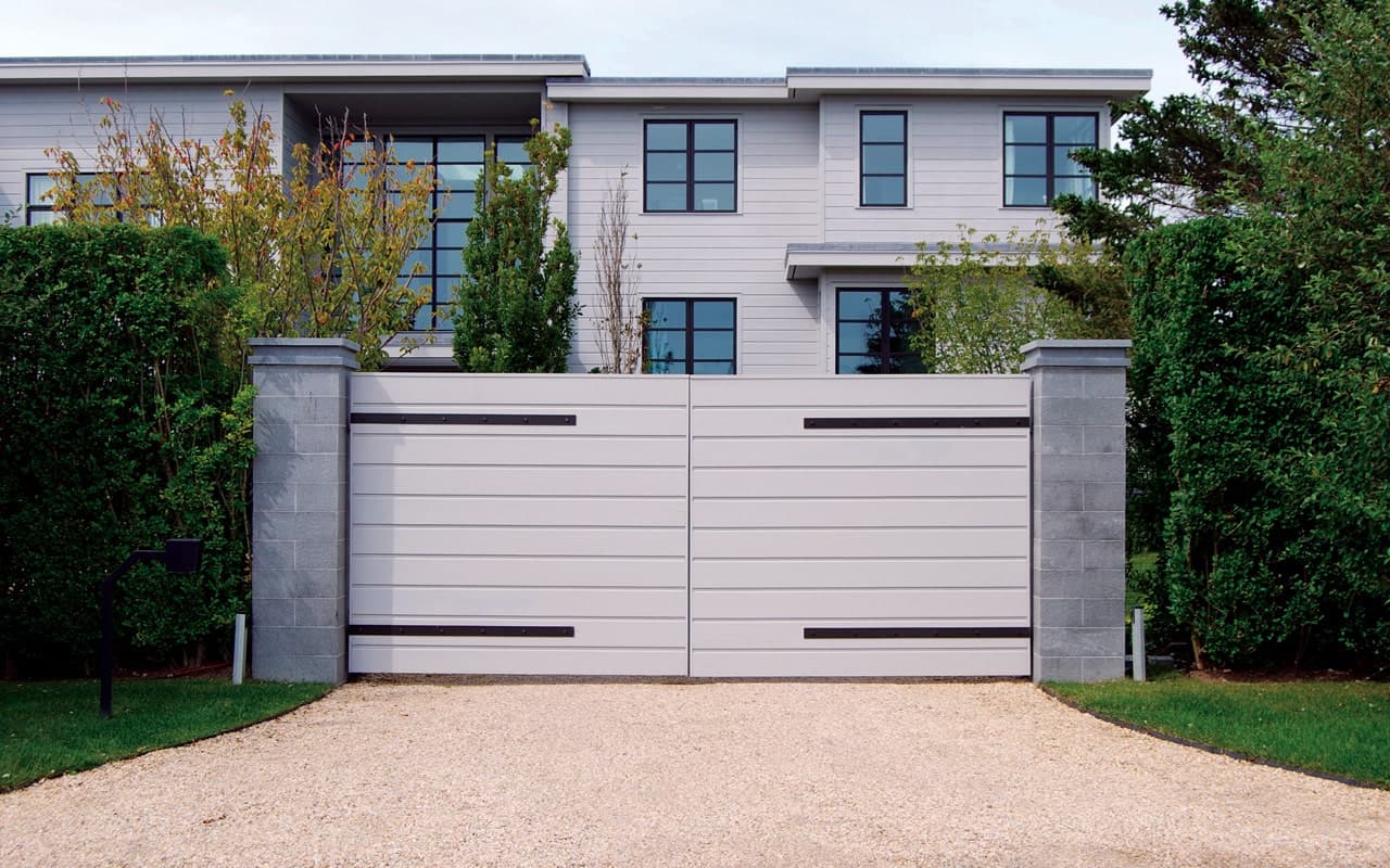 a driveway gate in front of a house