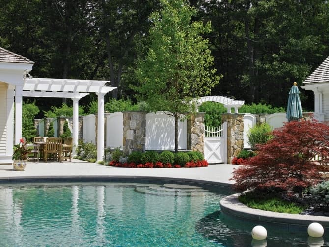 a pool with a fence in the backyard