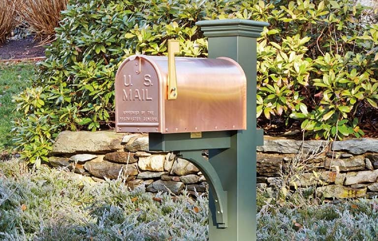 a mailbox by a rockwall