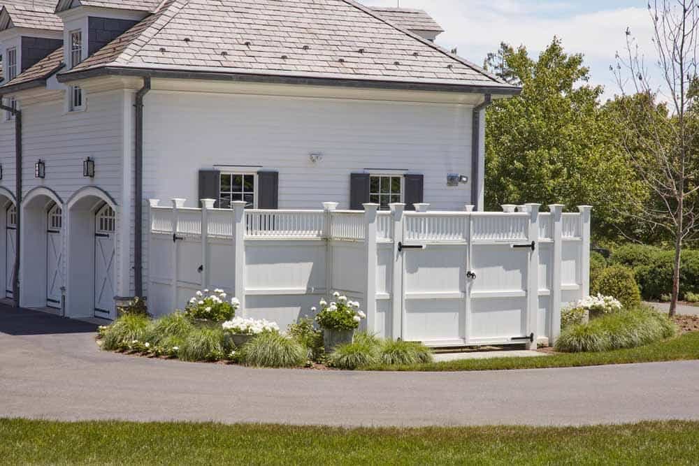 Side of house with a large fence door