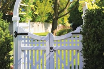 a gate with a yard in the background